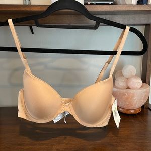 New with tags - Calvin Klein lightly lined Demi bra, 34B, in nude.